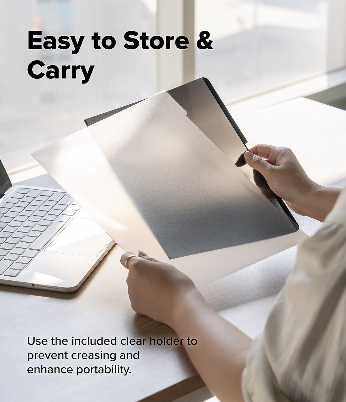 MacBook Neo | Magnetic AG Privacy Film - A person at a desk holds a clear protective cover over a tablet, with text reading 'Easy to Store & Carry' and additional usage text about using the included clear holder to prevent creasing and enhance portability.