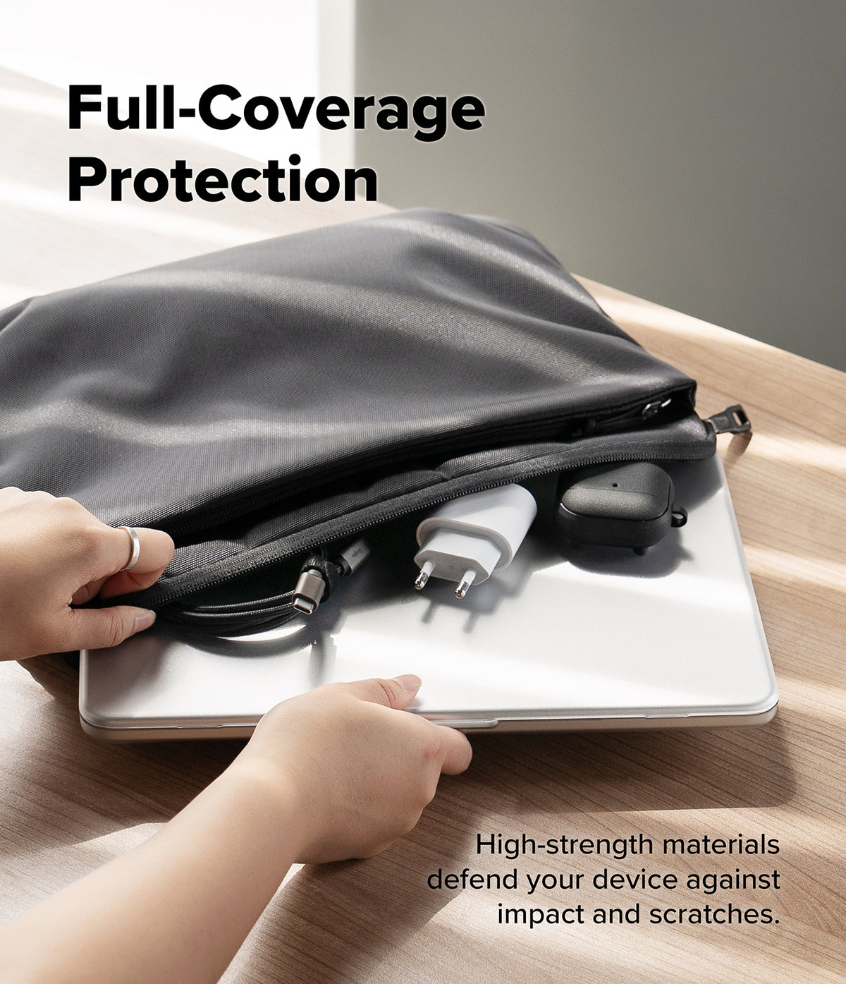 MacBook Neo | Slim - A black laptop sleeve with a built-in laptop protector pocket is shown on a wooden table, with hands demonstrating how to slide a laptop underneath the sleeve for full coverage. The text reads 'Full-Coverage Protection' and 'High-strength materials defend your device against impact and scratches.