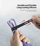 Silicone Cable Tie - Hands pulling a flexible black silicone strap to secure a purple patterned cable.
