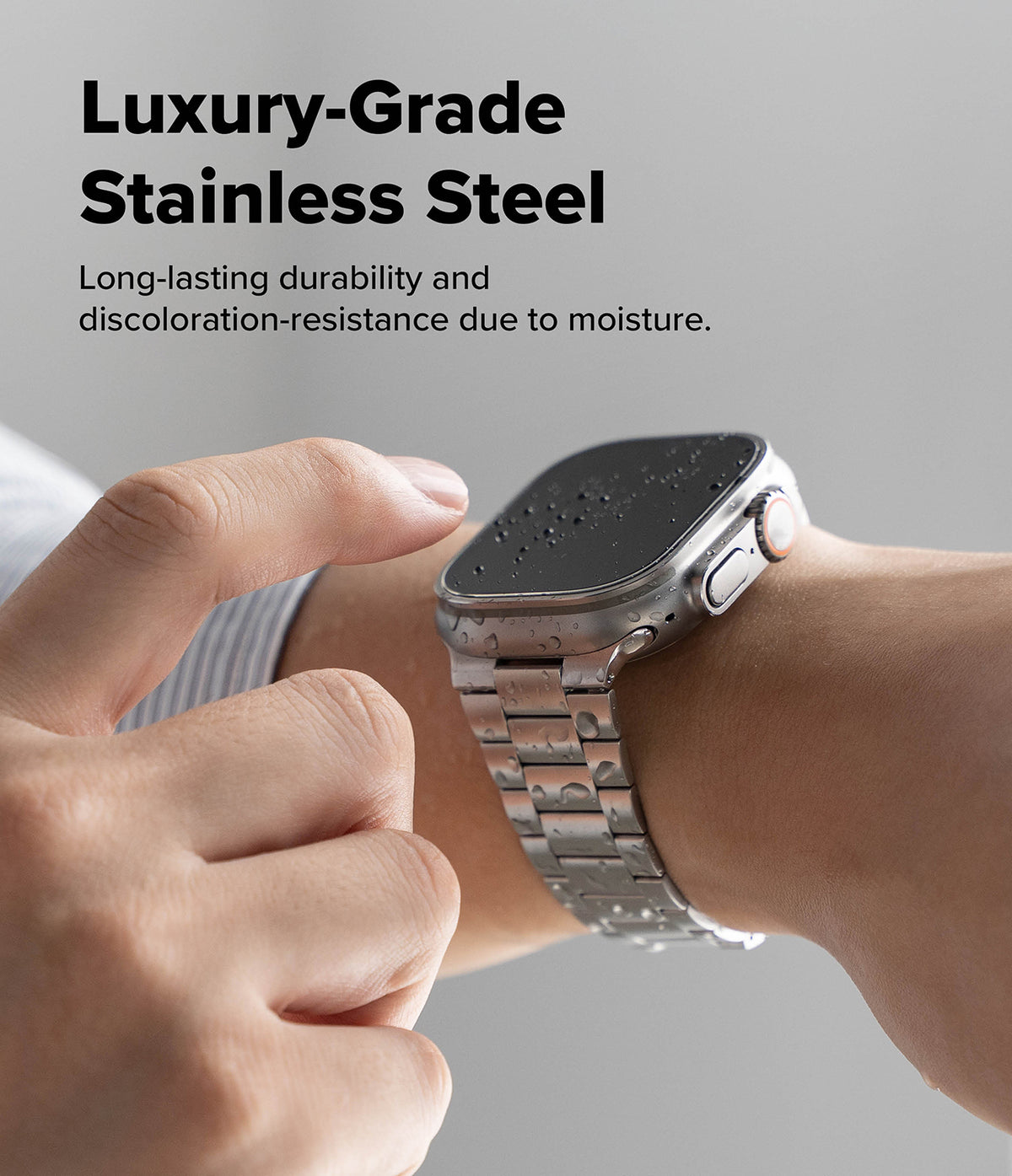 Apple Watch 49·46·45·44·42 mm | Metal One Air - Stainless steel watch band on wrist with water droplets on the screen.