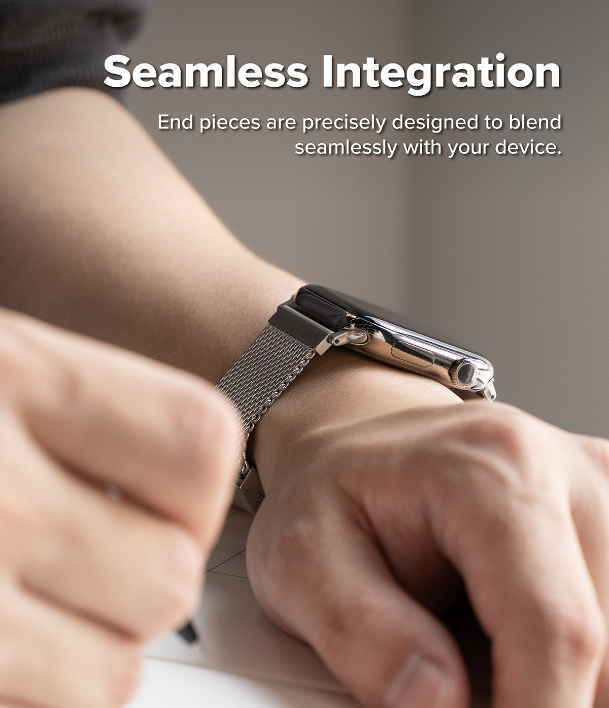 Apple Watch 49·46·45·44 mm | Metal One Mesh - Close-up of a smartwatch with a silver mesh band worn on a person's wrist, with overlaid text reading 'Seamless Integration' and smaller copy about the end pieces blending seamlessly with the device.