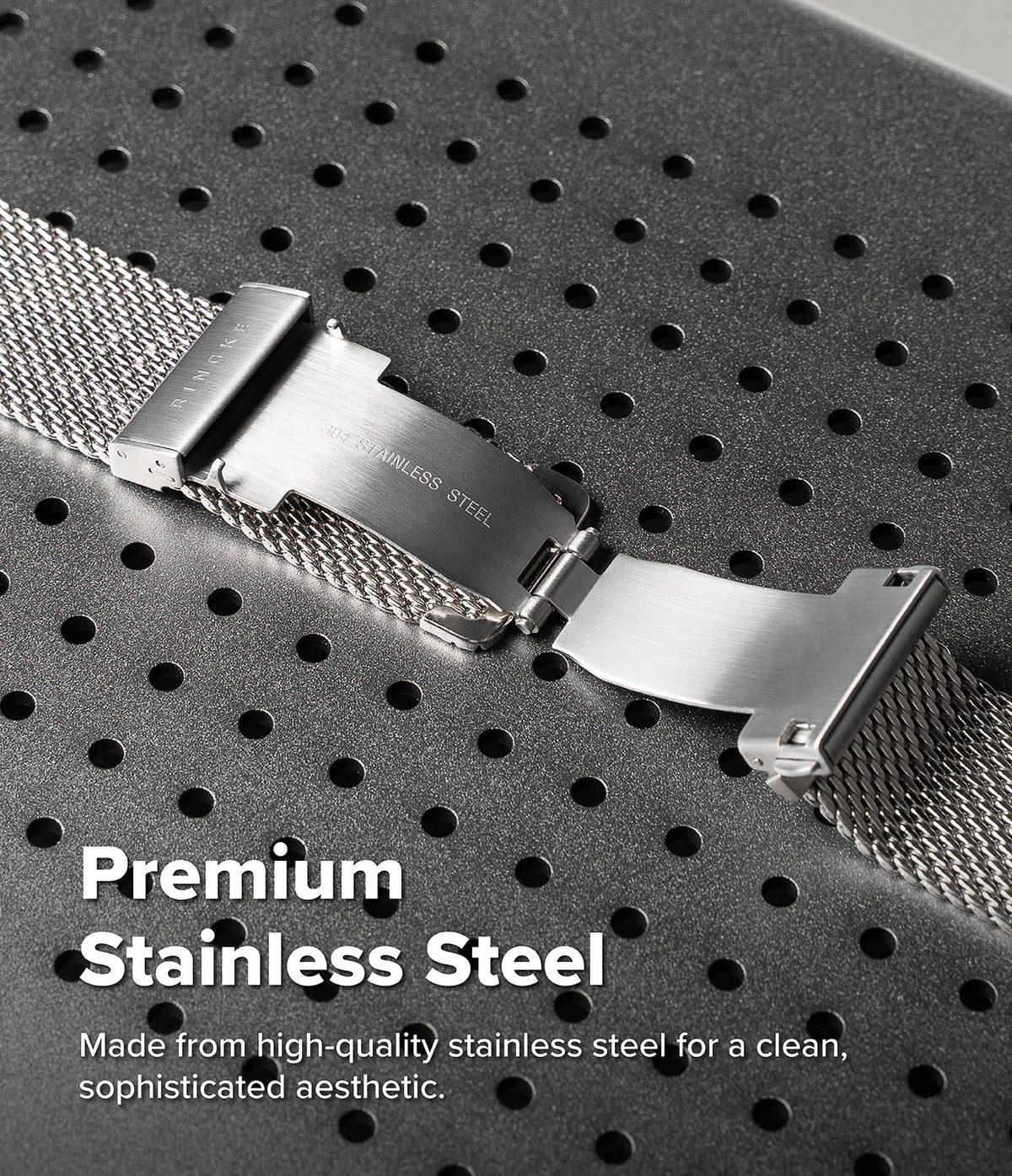 Apple Watch 49·46·45·44 mm | Metal One Mesh - Close-up of a stainless steel watch band clasp and mesh strap on a dark perforated surface, with text reading 'Premium Stainless Steel'.