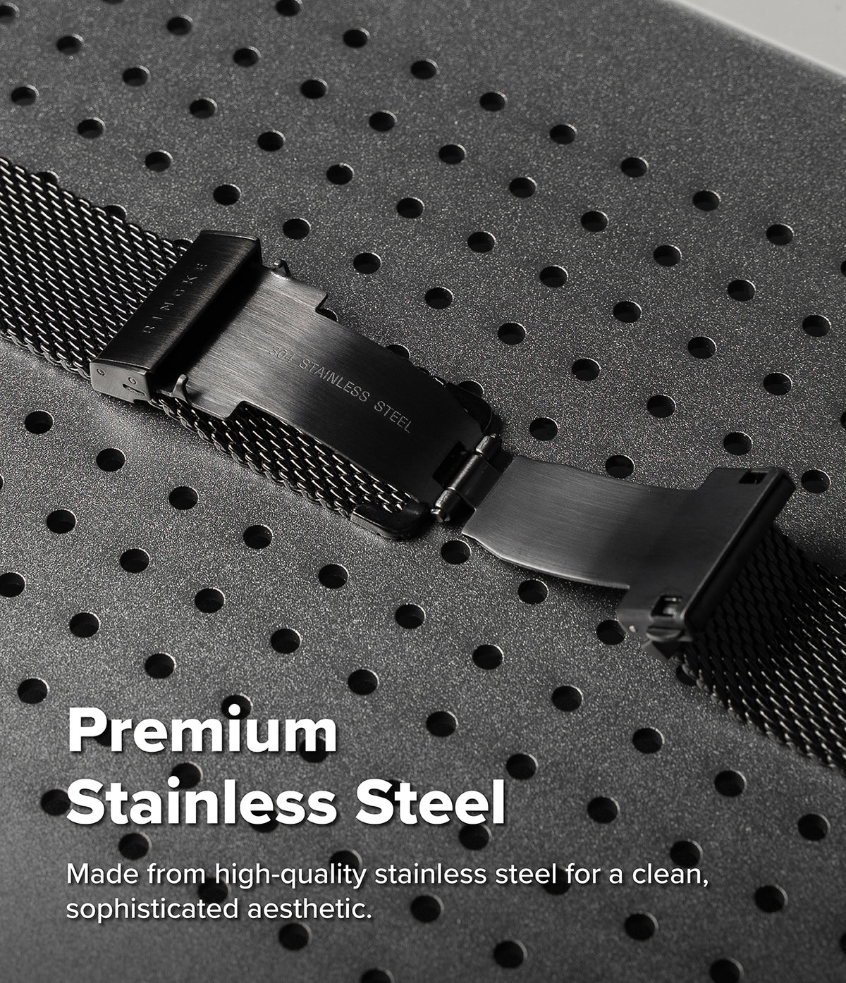 Galaxy Watch Ultra 2 / 1 | Metal One Mesh - Close-up of a black stainless steel watch band clasp and mesh strap on a dark perforated surface, with text reading 'Premium Stainless Steel'.