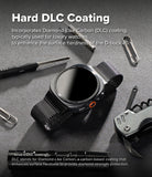 Galaxy Watch Ultra 2 / 1 | Metal One Mesh - A smartwatch with a black mesh band is shown on a dark textured surface with promotional text about DLC coating and surrounding tools including a screwdriver, paperclip, and folding knife.