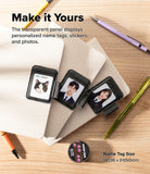 Pen Holder | Name Tag (2P) - Three personalized black name tag holders with transparent panels displaying cat, portrait, and woman photos, arranged on notebooks with pens on a wood desk. Text reads 'Make it Yours' and shows name tag size details.