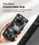 Nothing Phone (3a) Case | Fusion-X - Hand holding a camo-patterned phone case with textured side grips for a secure hold.
