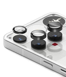 Nothing Phone (3) | Camera Glass - Three black circular lens protectors hovering above the camera lenses on a white phone.