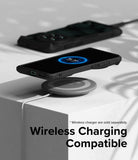 OnePlus 12 Case | Fusion-X - A black smartphone in a rugged case wirelessly charging on a grey pad atop a white block.