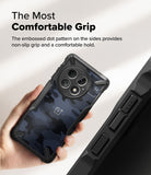 OnePlus 13 Case | Fusion-X - Hand holding a blue camo phone case with textured side grips and a circular camera cutout.