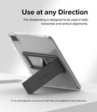 Outstanding | Tablet Stand - A gray tablet stand attached to the back of a clear-cased tablet, propped up on a white surface.