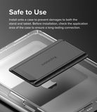 Outstanding | Tablet Stand - A dark gray adhesive tablet stand hovering above a clear protective tablet case.