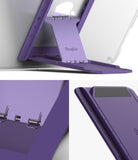 Outstanding | Tablet Stand - Purple foldable tablet stand attached to a device with adjustable metal hinges and angle markings.