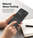 Poco F7 Screen Protector | Easy Slide Tempered Glass - Poco F7 Screen Protector - Hands holding a smartphone with a tempered glass screen protector while typing on the keyboard.
