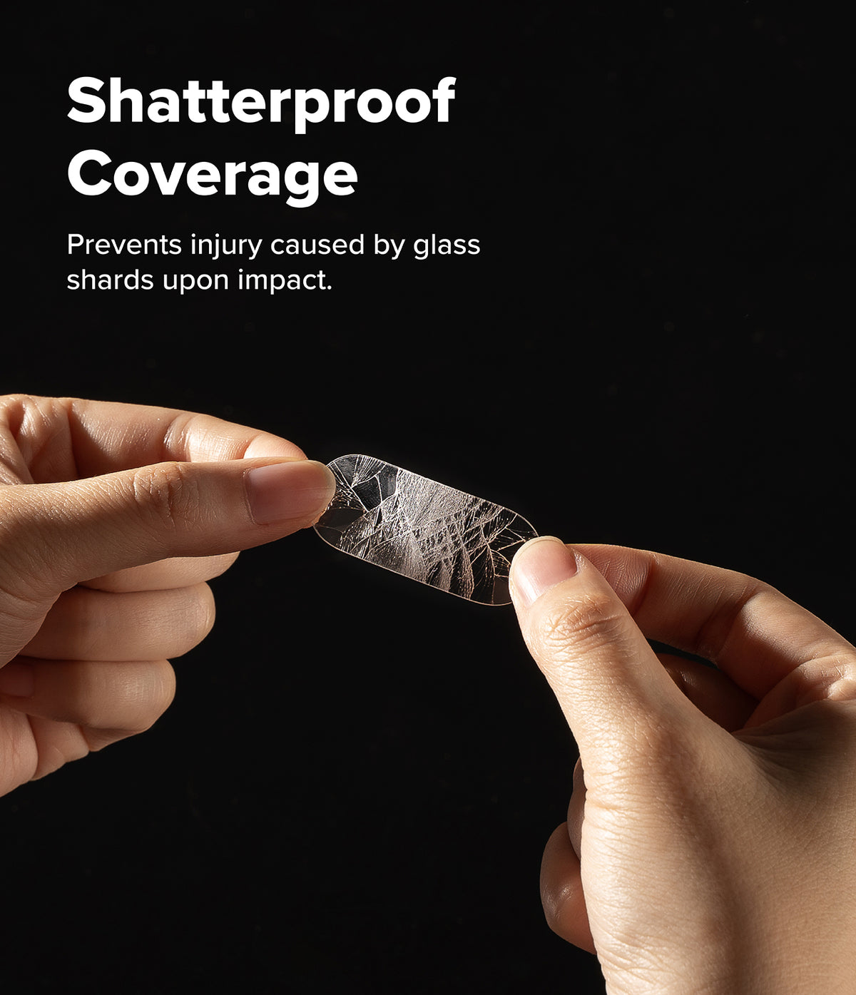 Google Pixel 10 Pro | Camera Glass - Hands holding a cracked, shatterproof camera lens protector against a black background.