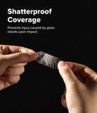 Google Pixel 10 Pro | Camera Glass - Hands holding a cracked, shatterproof camera lens protector against a black background.