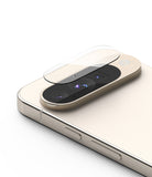 Google Pixel 10 | Camera Glass - A clear glass lens protector hovering above the triple-camera module of a gold smartphone.