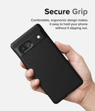 Google Pixel 7a Case | Onyx - A hand holding a black textured phone case with a camera cutout against a light background.