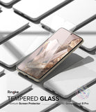 Google Pixel 8 Pro Screen Protector | Glass - Google Pixel 8 Pro Screen Protector - Tempered glass film hovering over a Pixel 8 Pro phone amidst white phone models.