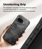 Google Pixel 9a Case | Onyx - Hand holding a black camo-patterned phone case with a textured grip.