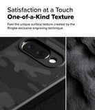 Google Pixel 9a Case | Rugged Gear - Close-up of a textured camo phone case next to a rough, grainy surface texture.
