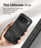 Google Pixel 9 Pro XL Case | Onyx - Hand holding a black camo-patterned phone case with textured sides for grip.