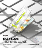 Google Pixel 9a Screen Protector | Easy Slide Tempered Glass - Google Pixel 9a Screen Protector - Easy Slide installation tool hovering over a smartphone on a grid of blank phones.