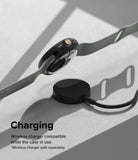 Google Pixel Watch 3 45mm | Slim - A black protective case on a smartwatch hovering above a wireless charging puck.