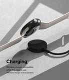 Google Pixel Watch Case | Slim - A black protective case on a Pixel Watch hovering above a wireless charging puck.
