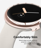Google Pixel Watch Case | Slim - Close-up of a rose gold protective case on a Pixel Watch with a light-colored band.