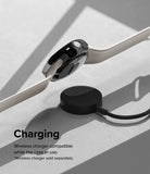 Google Pixel Watch Case | Slim Edge - A Google Pixel Watch with a slim black case charging on a wireless puck.