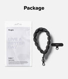 Holder Link Puffer | Hand - Ringke puffer hand strap with a black metal clip and a rectangular mounting tab in packaging.