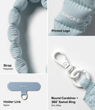 Holder Link Puffer | Hand - Light blue quilted strap, Ringke logo, nylon holder link, and white zinc alloy swivel carabiner.