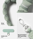 Holder Link Puffer | Hand - Sage green quilted polyester strap, nylon holder link, and white zinc alloy swivel carabiner.