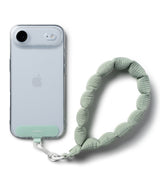 Holder Link Puffer | Hand - Sage green quilted puffer wrist strap attached to a clear phone case with a matching tab.