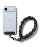 Holder Link Puffer | Hand - Smartphone in a clear case with a black Ringke anchor attached to a puffy black wrist strap.