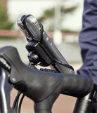 Quick & Go | Grip Bike Mount - A smartphone secured to bicycle handlebars with a black silicone strap mount.