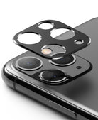 iPhone 11 Pro / Pro Max | Camera Styling - A black protective camera lens cover hovering above an iPhone 11 Pro camera array.