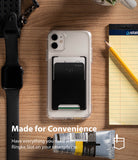 Card Holder | Slot [3 Cards] - Black adhesive card holder on a clear phone case, surrounded by a watch, notepad, and paint tube.