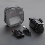 Travel Organizer Pouch - Grey mesh pouch with camera, USB cable, and memory card reader on a dark grey background.