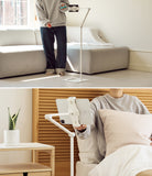 Ringke Stand Floor Holder - Adjustable white floor stand holding a tablet for gaming and bedside use in a home setting.