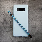 Paracord Lanyard Wrist Strap [2 Pack] - Blue and black patterned paracord wrist strap attached to a light blue phone case.