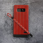Paracord Lanyard Wrist Strap [2 Pack] - Red and black patterned paracord lanyard attached to a red phone case on gray stone.