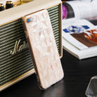 iPhone 8 Plus / 7 Plus Case | Air Prism - Clear glitter phone case with a geometric prism pattern leaning on a speaker.