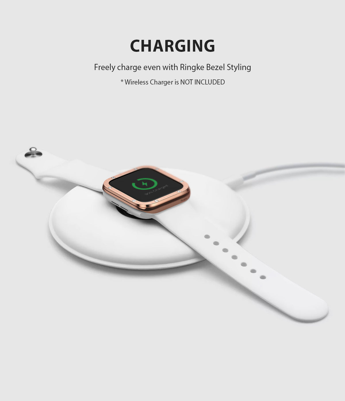 Apple Watch Series 3 / 2 / 1 (42mm) | Premium Bezel Styling H - Rose gold bezel on a white Apple Watch charging wirelessly.