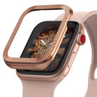 Apple Watch Series 3 / 2 / 1 (38mm) | Premium Bezel Styling O - Rose gold ridged bezel cover hovering over a watch.