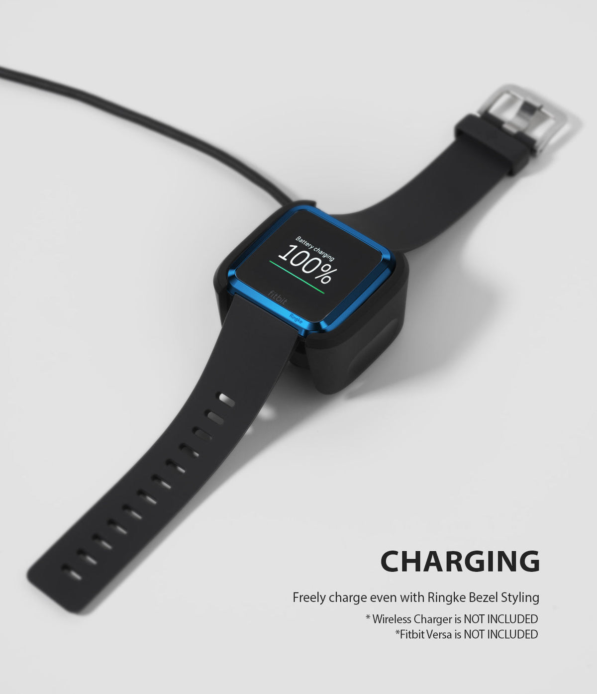 Fitbit Versa | Bezel Styling 04 - A Fitbit Versa with a blue bezel accessory charging on a wireless dock.
