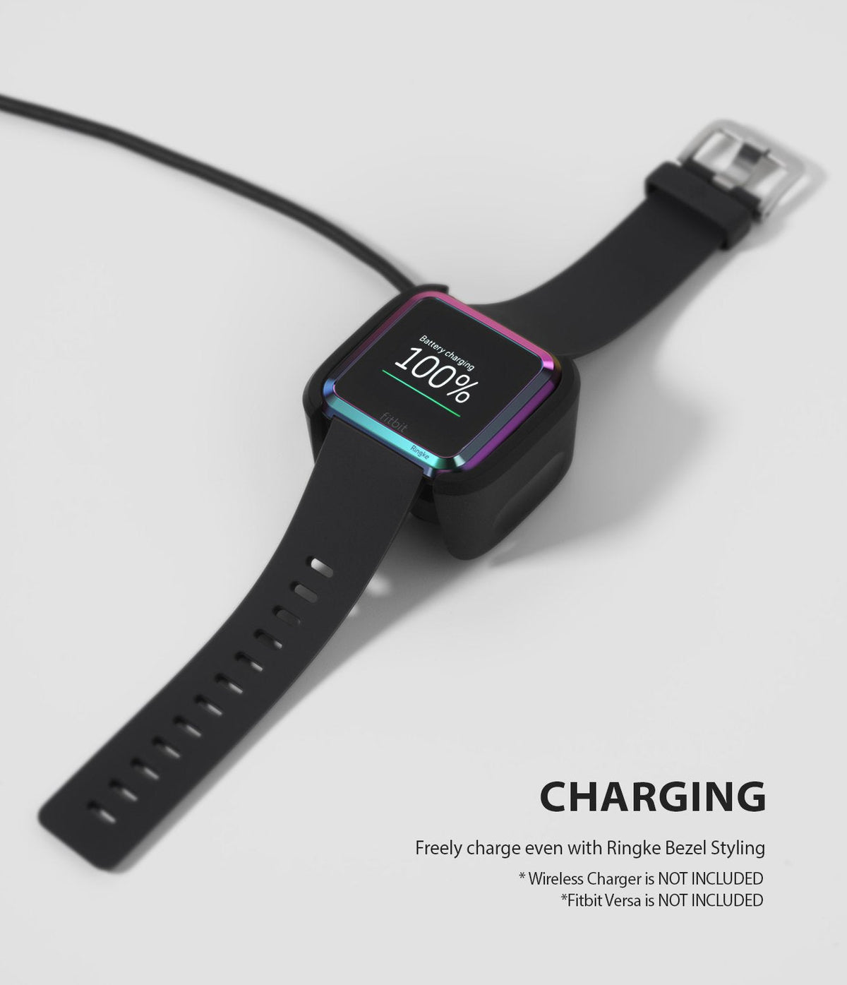 Fitbit Versa | Bezel Styling 08 - A Fitbit Versa with a rainbow-colored bezel styling accessory charging on a dock.