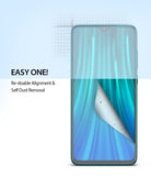 Redmi Note 8 Pro Screen Protector | Dual Easy Film - Redmi Note 8 Pro Screen Protector - Smartphone screen with a partially peeled film showing dust removal technology.