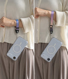 Dual Hand Slim Strap - A person wearing a colorful wrist strap attached to a clear phone case with a MagSafe ring.