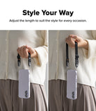 Dual Hand Slim Strap - Person holding a phone with an adjustable black wrist strap shown at two different lengths.